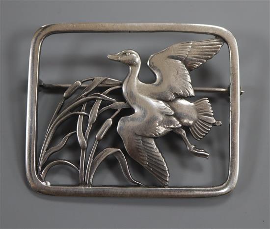 A Danish Georg Jensen sterling duck in flight amid bulrushes rectangular brooch, no.300, 47mm.